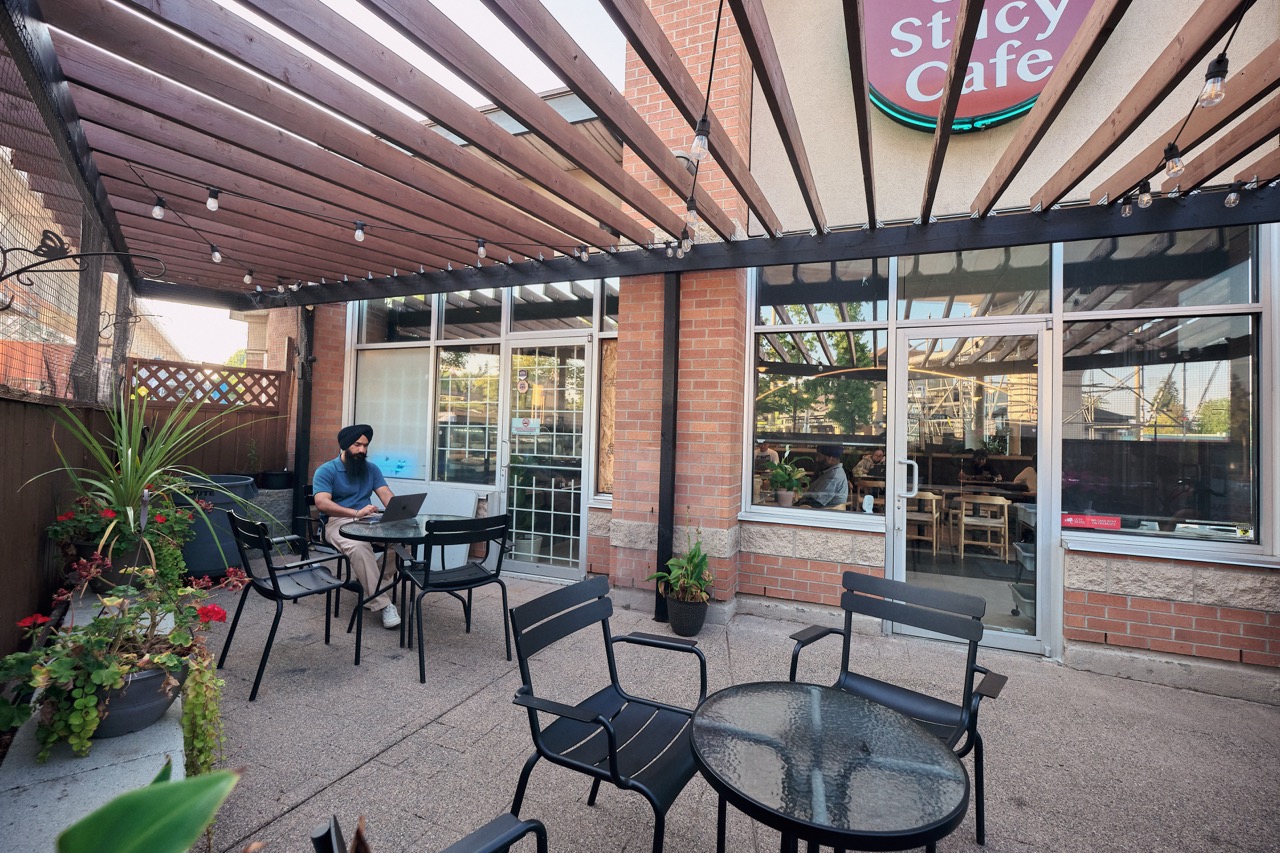 The covered patio at Stucy Cafe, with string lights and a timber pergola.